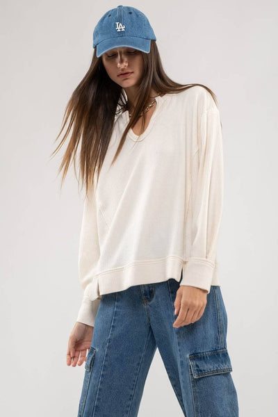 RAW EDGE SPLIT NECK AND HEM RIB KNIT TOP: CREAM