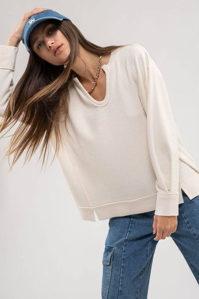 RAW EDGE SPLIT NECK AND HEM RIB KNIT TOP: CREAM